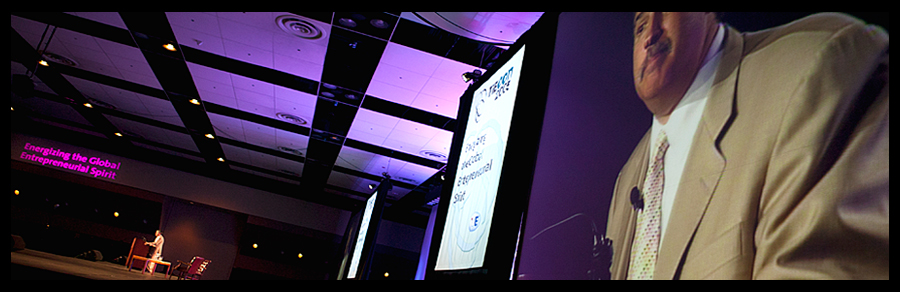 Keynote showing stage of huge ballroom and speaker on giant projection